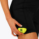 Woman wearing the Osaka women tech short thights in black with grey logo. Front detail pocket view
