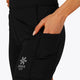 Woman wearing the Osaka women tech short thights in black with grey logo. Front detail pocket view