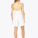 Woman wearing the Osaka women pleated tech dress in white with grey logo. Back view