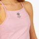 Woman wearing the Osaka women pleated tech dress in pink with grey logo. Front detail logo view