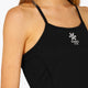 Woman wearing the Osaka women pleated tech dress in black with grey logo. Front detail logo view