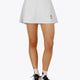 Woman wearing the Osaka women floucy skort white with logo in grey. Front view