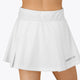 Woman wearing the Osaka women floucy skort white with logo in grey. Back view