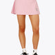 Woman wearing the Osaka women floucy skort pink with logo in grey. Front view
