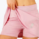 Woman wearing the Osaka women floucy skort pink with logo in grey. Front detail short view