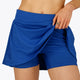 Woman wearing the Osaka women floucy skort princess blue with logo in grey. Front detail short view