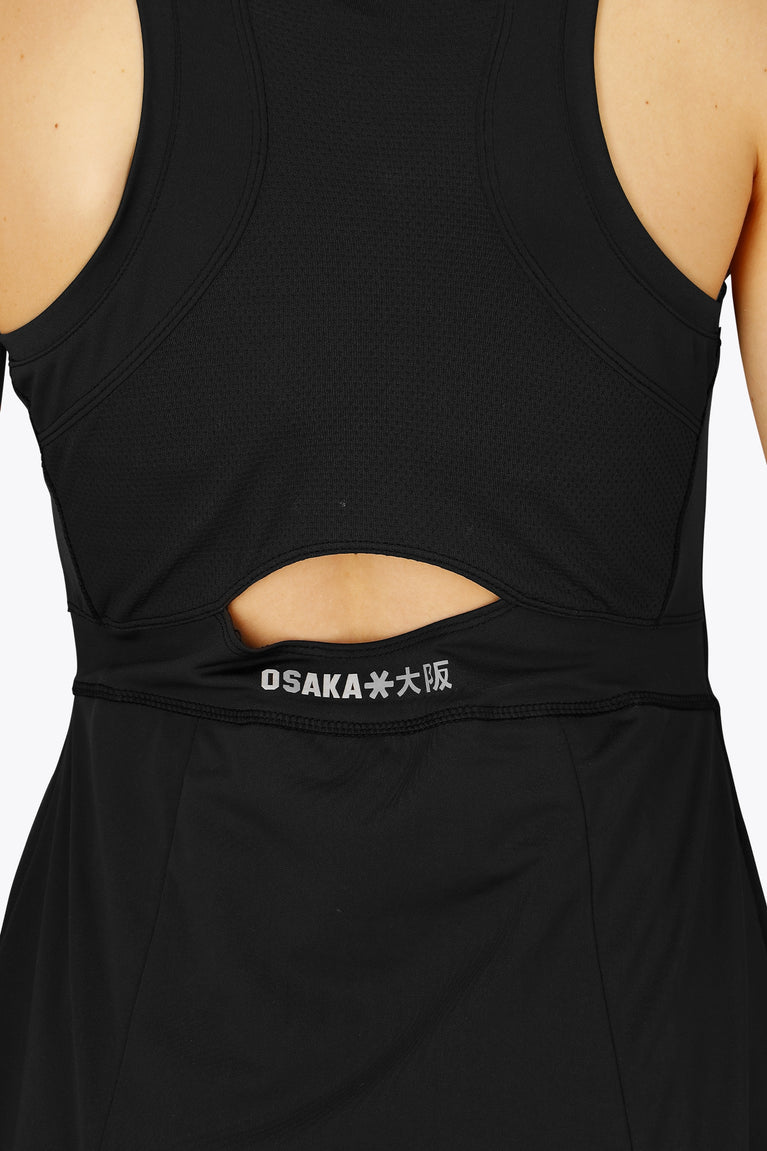 Woman wearing the Osaka women floucy dress black. Back detail open back view