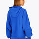 Woman wearing the Osaka women cropped hoodie inprincess blue with college logo in white. Back view