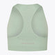 Osaka women tech sports bra in jadeite with logo in grey. Back flatlay view