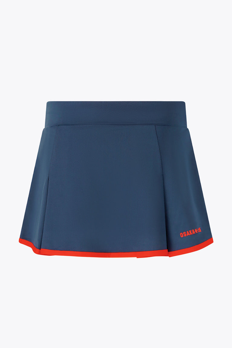 Women’s floucy skort by Olympian dark navy with red trim and back logo.