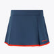 Women’s floucy skort by Olympian dark navy with red trim and back logo.