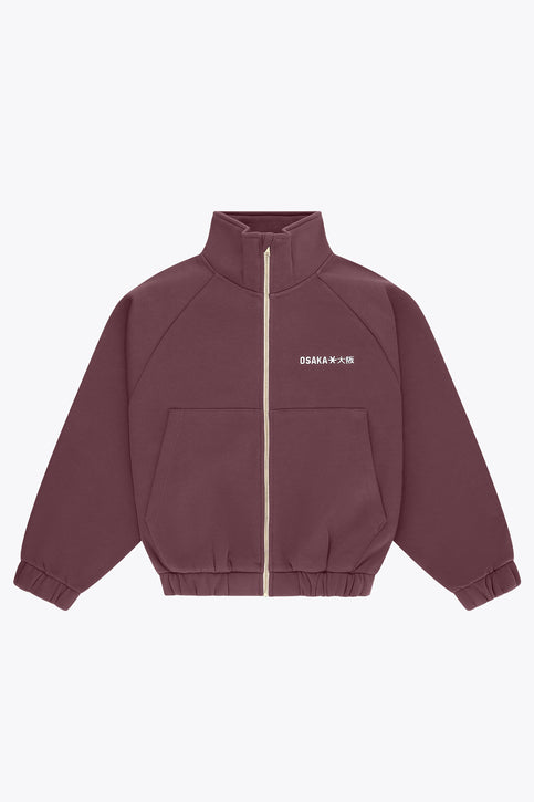 Women’s full-zip sweater with stand collar, front pockets, and gold zipper in plum