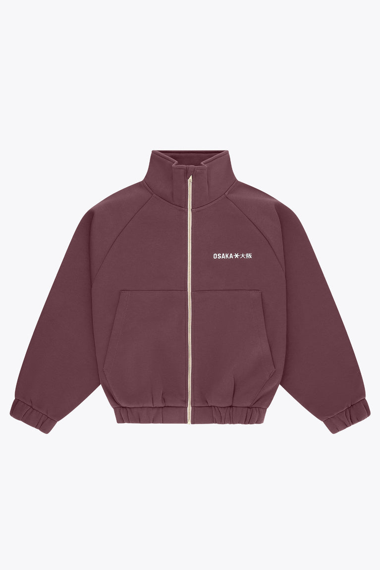 Women’s full-zip sweater with stand collar, front pockets, and gold zipper in plum
