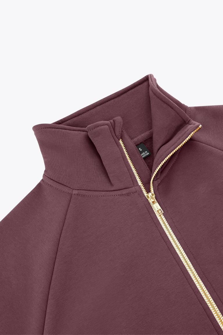 Plum zip-up sweater close-up with stand collar and gold zipper trim