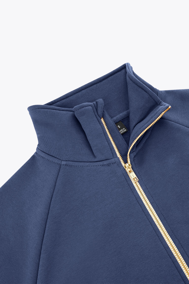 Women’s full-zip sweater close-up of high collar and gold-trim zipper