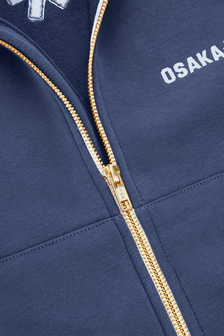 Women’s full-zip sweater chest close-up with gold zipper and “OSAKA” text