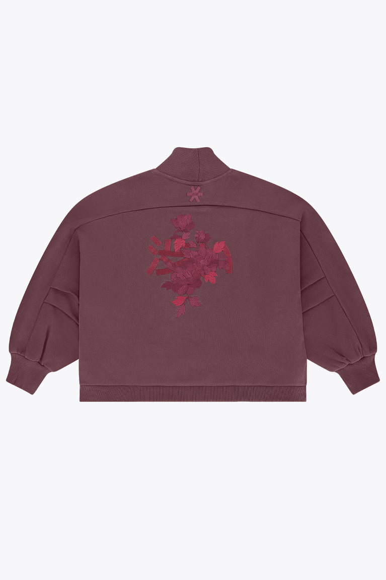 Women’s mockneck sweater back view in dark plum with red floral graphic