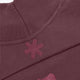 Women’s mockneck sweater shoulder close-up with ribbed collar and snowflake patch