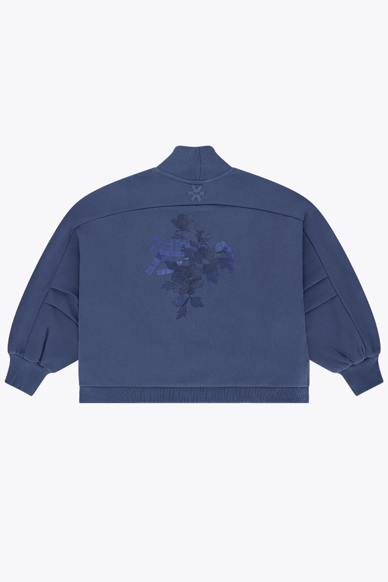 Blue women’s mockneck sweater with back embroidered floral graphic and snowflake