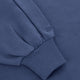 Blue sweater sleeve cuff with ribbed knit trim and small embroidered detail