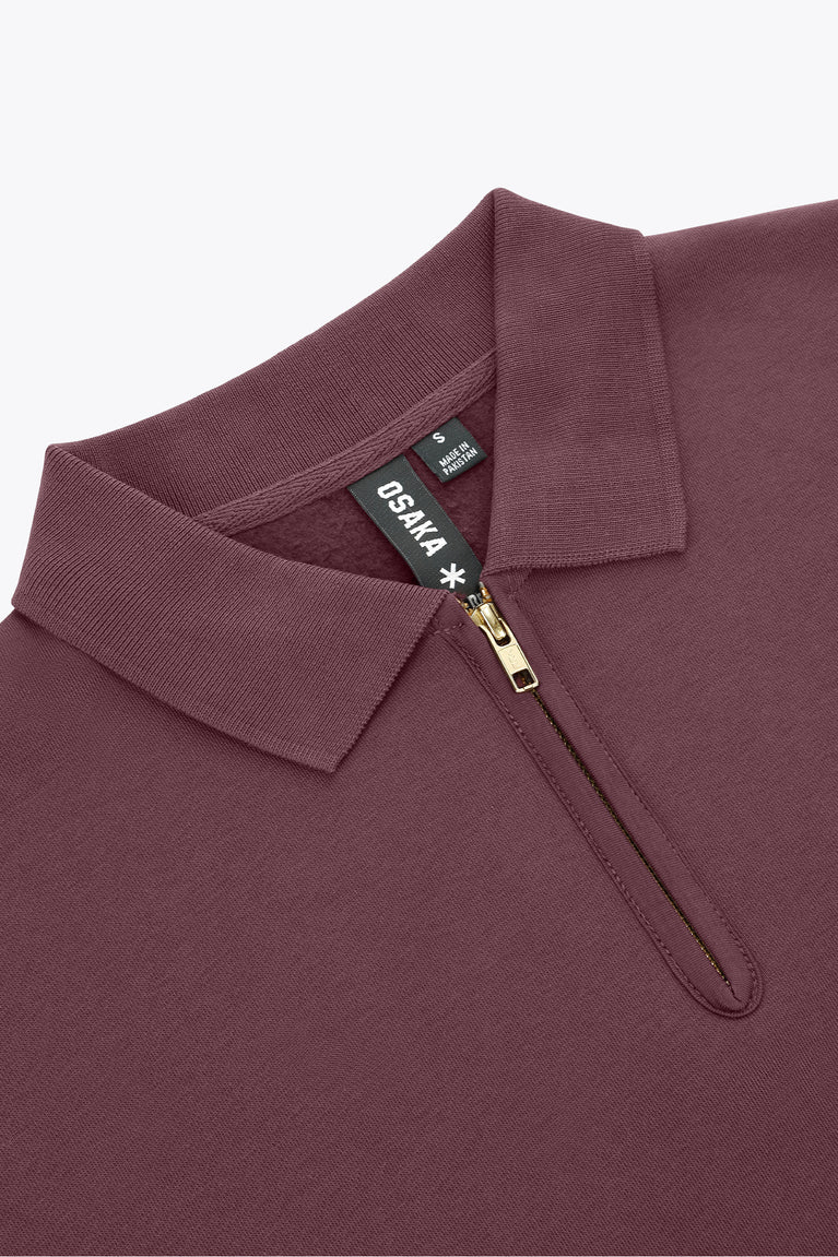 Women’s Osaka polo zip sweater close-up: ribbed collar, half-zip with metal pull, tag