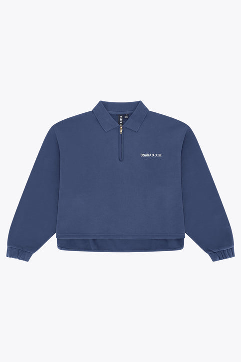 Blue women’s zip polo sweater with ribbed cuffs and hem, front quarter zip