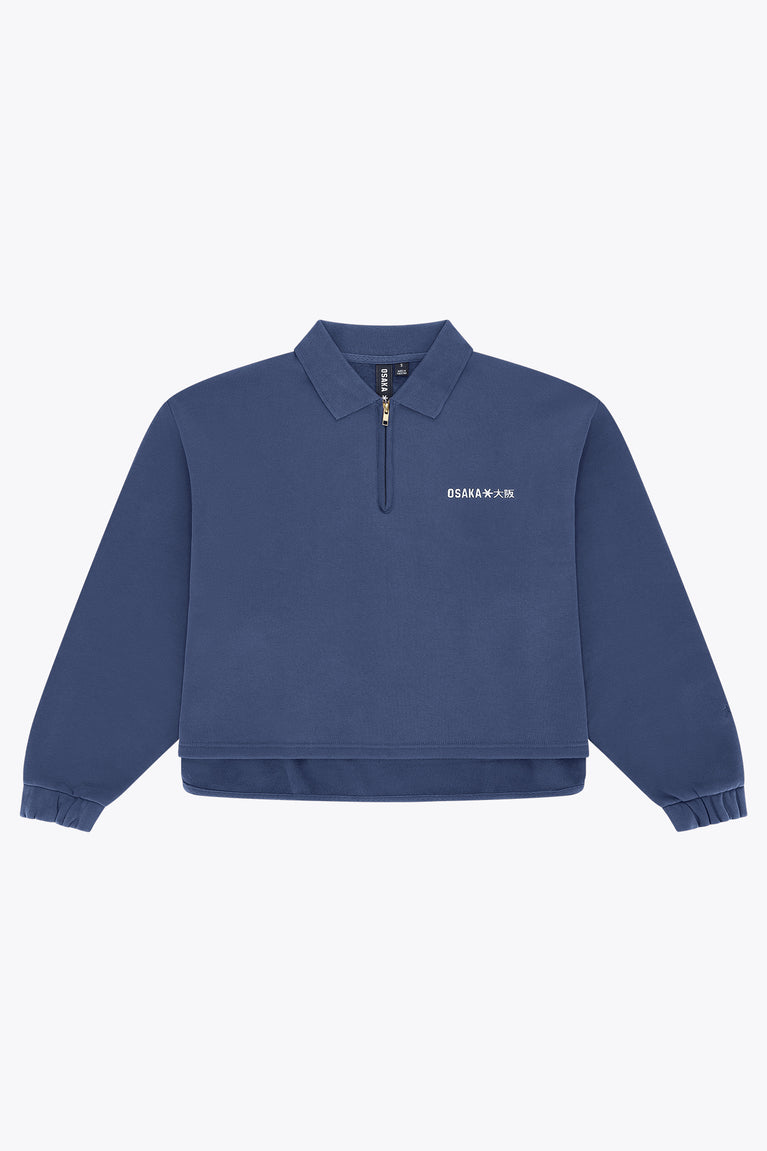 Blue women’s zip polo sweater with ribbed cuffs and hem, front quarter zip