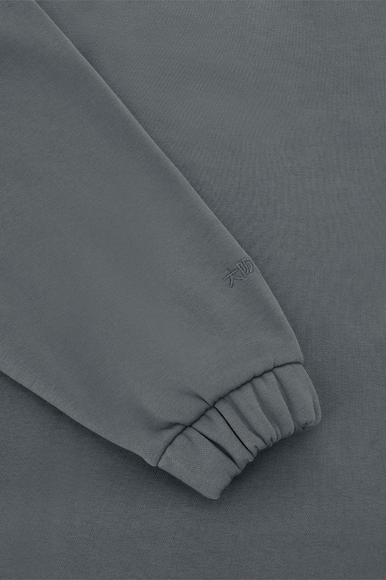 Women’s dark grey zip polo sweater, ribbed cuff with subtle embroidered mark