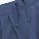 Close-up of dark blue wide-leg sweatpants waistband with elastic ribbing and stitched front