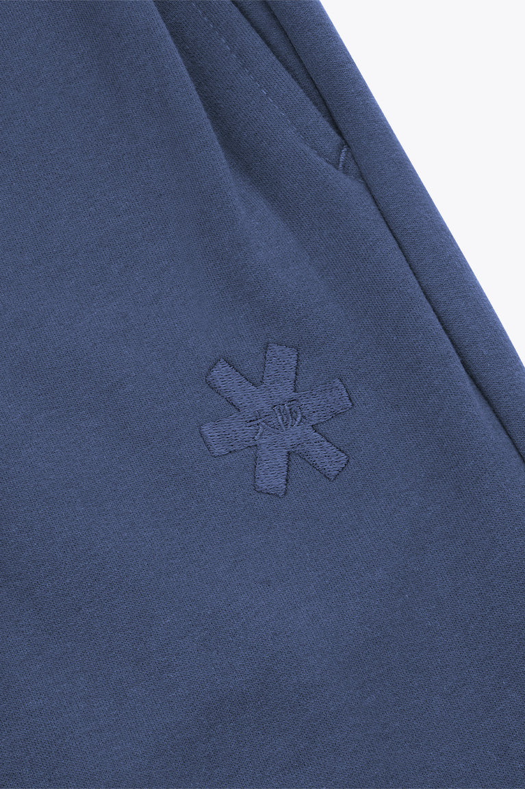 Dark blue sweatpants with small embroidered cross logo on the front