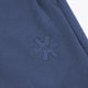 Dark blue sweatpants with small embroidered cross logo on the front