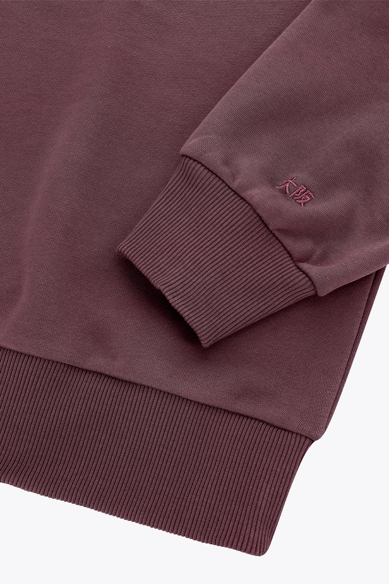 Men's pullover sweater sleeve and hem in dark maroon with ribbed cuffs and waistband