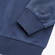 Dark blue sweater sleeve cuff with ribbed knit and small logo detail