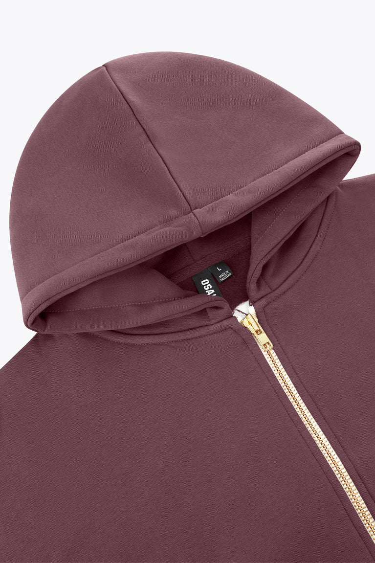 Men's full-zip hoodie close-up, dark maroon hood and gold zipper with tag