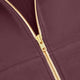 Men's full-zip hoodie zipper close-up, dark maroon jacket with gold chain zipper