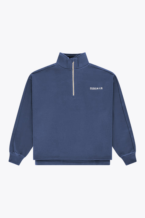 Men's navy half-zip sweater with stand collar and yellow zipper trim.