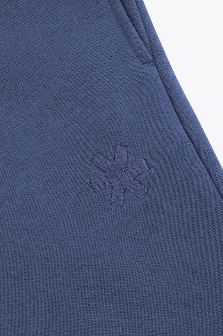 Blue sweatpants with small embroidered snowflake detail on the leg