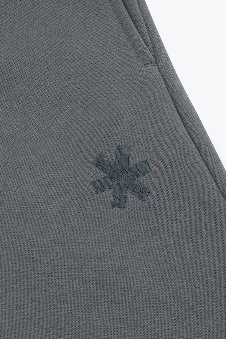 Dark grey melange sweatpants with small star-like logo detail on thigh.