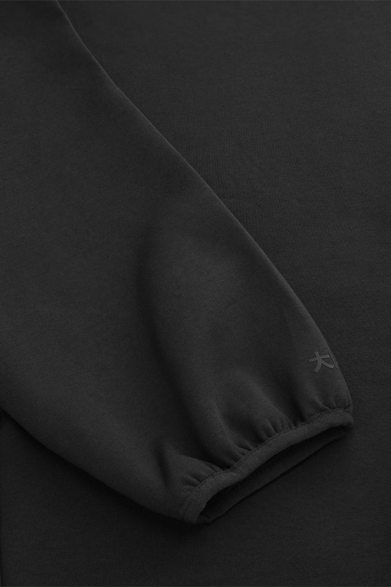 Black unisex hoodie sleeve with ribbed cuff and smooth fabric finish.