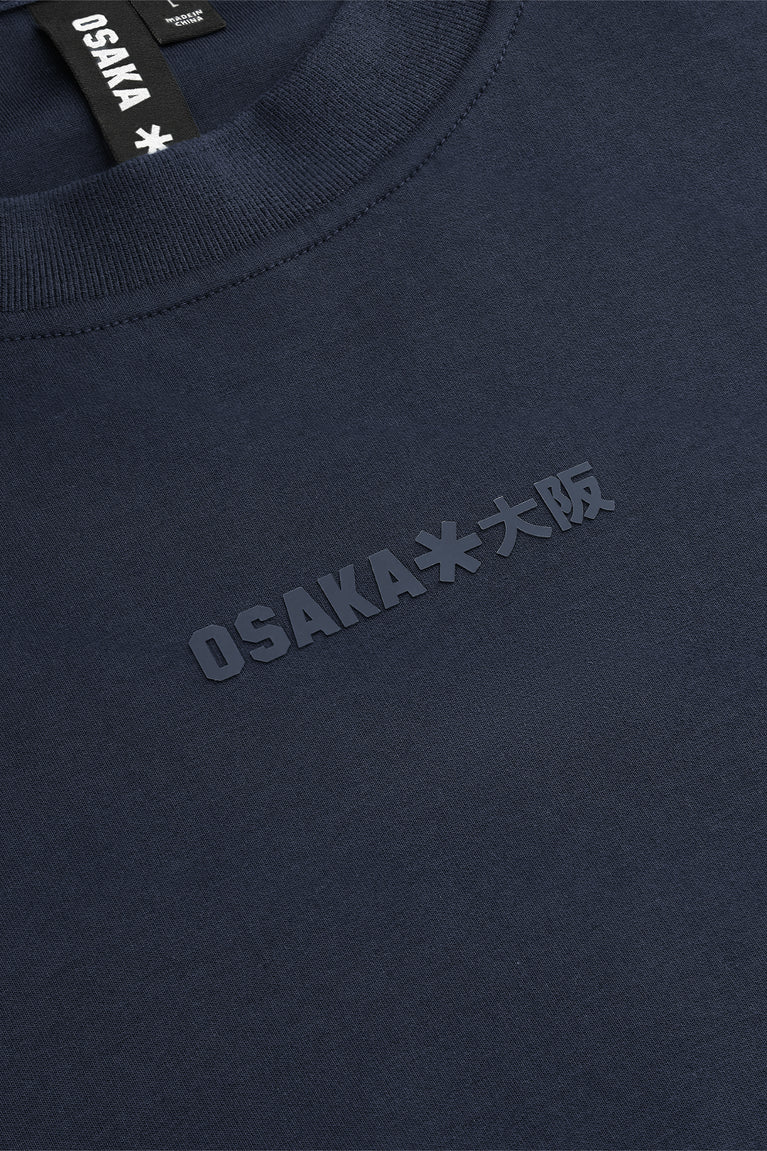 Navy knit sweater chest with subtle embossed star-and-text graphic logo