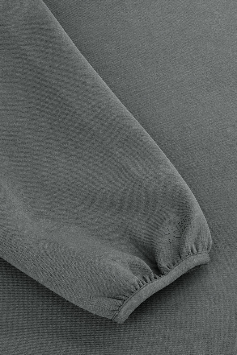 Unisex sweater sleeve cuff close-up in dark grey melange with ribbed knit