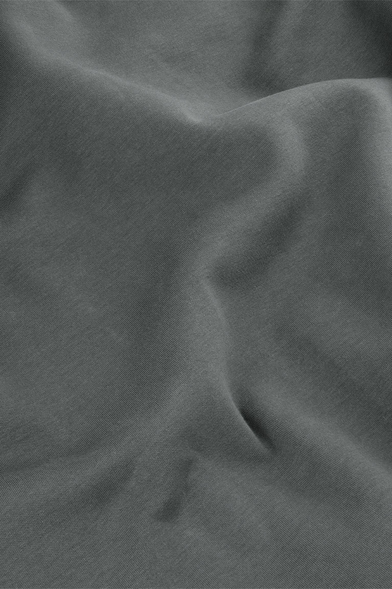 Unisex sweater knit close-up in dark grey melange, textured fabric folds