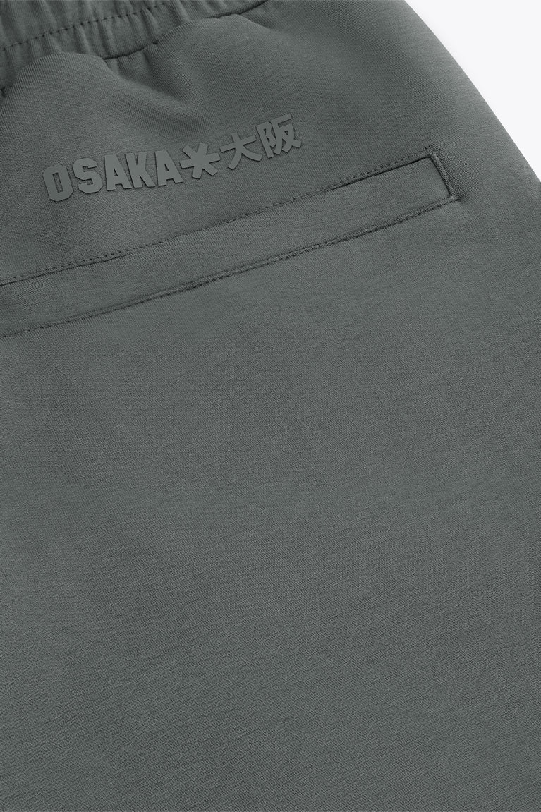 Dark grey sweatpants with raised logo print near the waistband