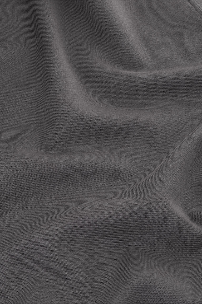 Dark grey T-shirt fabric close-up with smooth knit texture