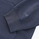 Deep sea navy hoodie sleeve with ribbed cuff and small Yibbi emblem