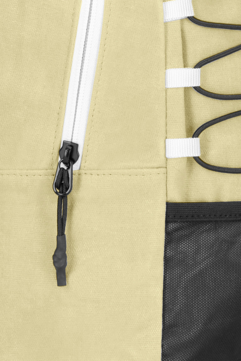 Osaka pro tour backpack in faded yellow with logo in white. Detail zip view