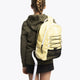 Osaka pro tour backpack in faded yellow with logo in white. Girl wearing the bag