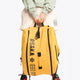 Pro Tour padel bag in honey comb with logo in black. Woman holding the bag 