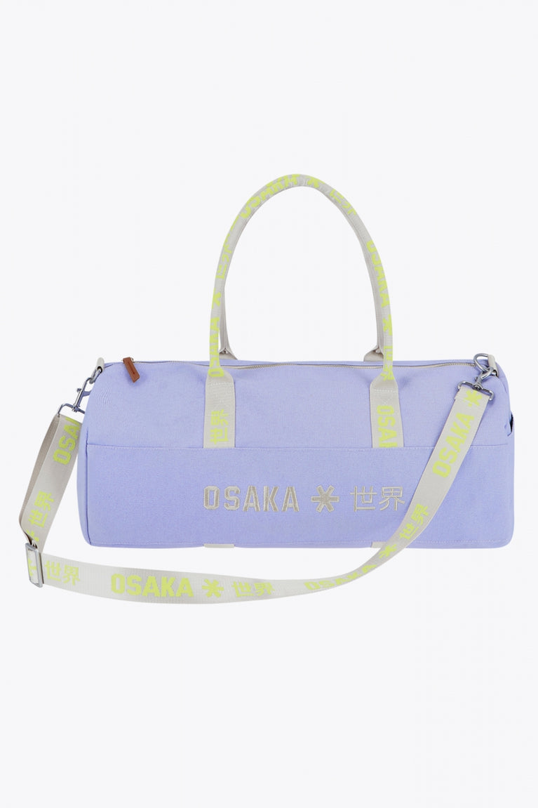 Osaka cotton duffel in light purple with logo. Front view with strap