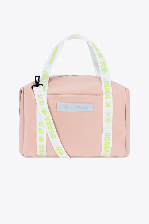 Osaka neoprene duffel bag in powder pink with logo in white on the bag and in green on the straps. Front view